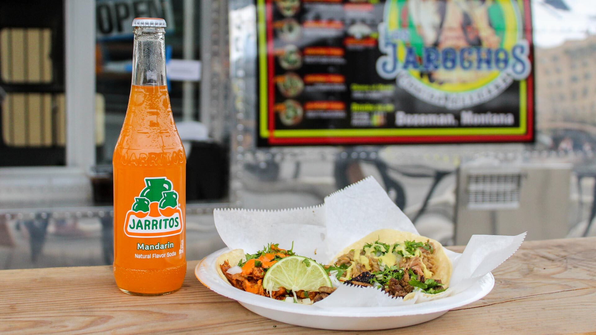 Close-up image of street tacos, and a glass Jarritos soda outside a food truck outside our downtown Bozeman hotel